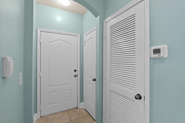 doorway to outside featuring light tile patterned flooring