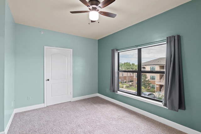 spare room with carpet and ceiling fan