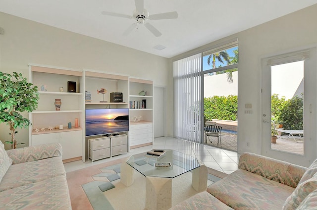 living room featuring ceiling fan and light tile patterned flooring