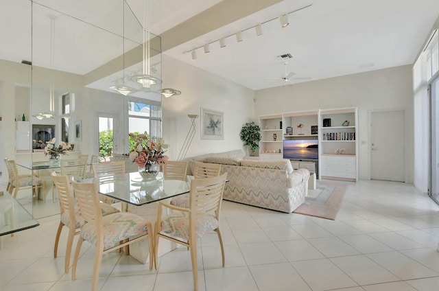 tiled dining area featuring ceiling fan and built in features