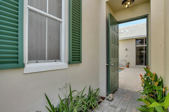 doorway to property with a patio