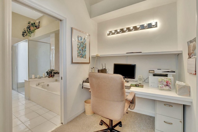 office with built in desk and light tile patterned floors