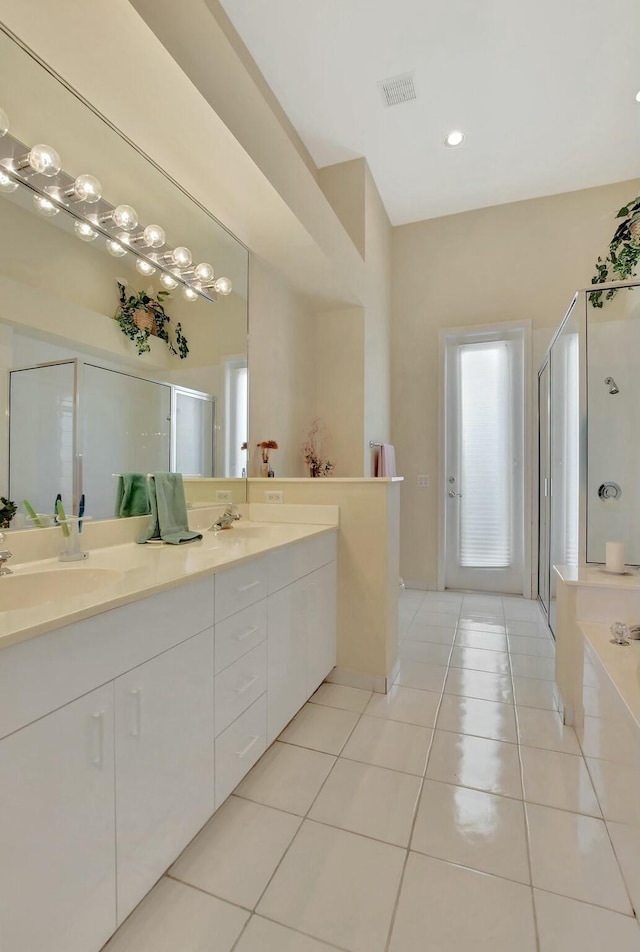 bathroom featuring tile patterned flooring, vanity, and plus walk in shower