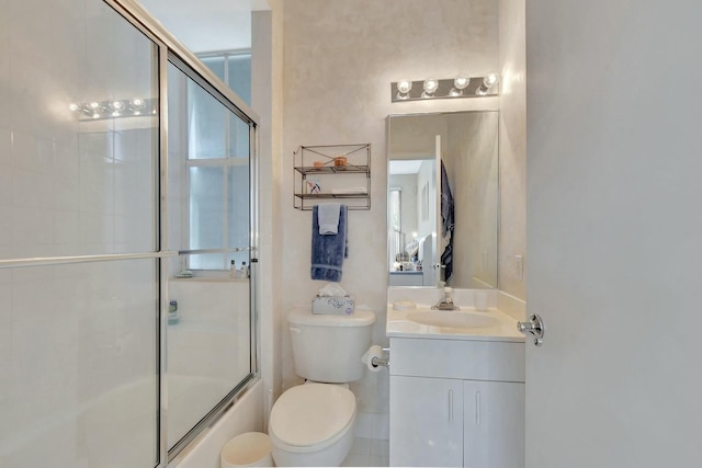 full bathroom featuring vanity, bath / shower combo with glass door, and toilet