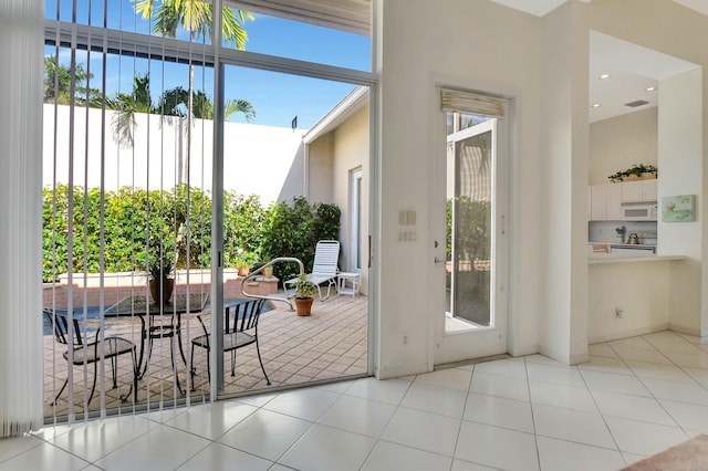 doorway with light tile patterned flooring