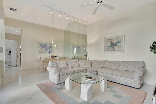 tiled living room with ceiling fan