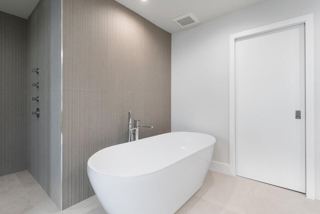 bathroom featuring tile patterned floors and plus walk in shower