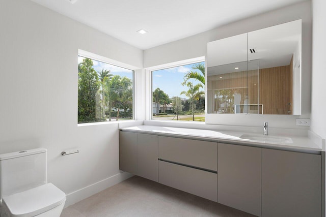 bathroom featuring tile patterned floors, vanity, and toilet