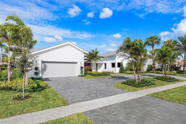 view of front of property with a front lawn and a garage