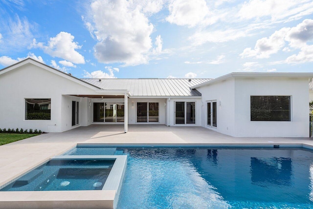 back of house with ceiling fan, a patio, and a swimming pool with hot tub