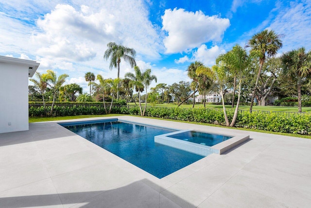 view of swimming pool featuring a patio and an in ground hot tub