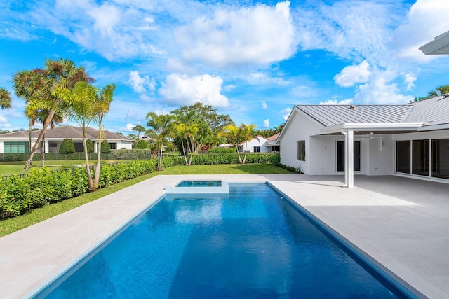 view of pool featuring a patio and an in ground hot tub