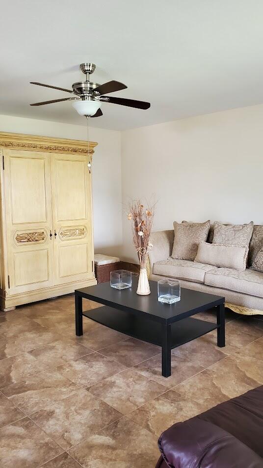 living room featuring a ceiling fan