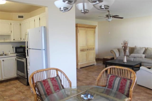 interior space with ceiling fan with notable chandelier and sink