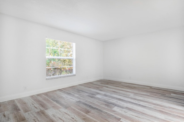 spare room featuring light wood-type flooring