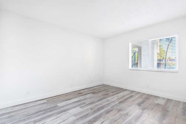 spare room with light wood-type flooring