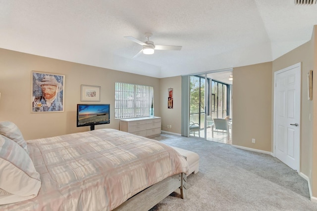 carpeted bedroom with a textured ceiling, access to outside, and ceiling fan