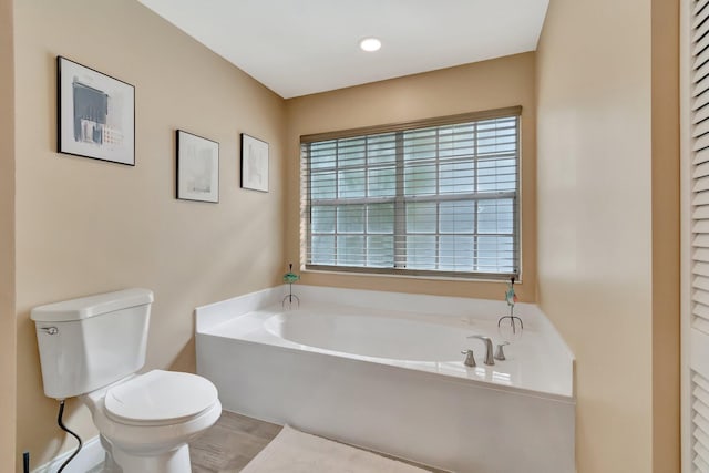 bathroom featuring a bathing tub and toilet