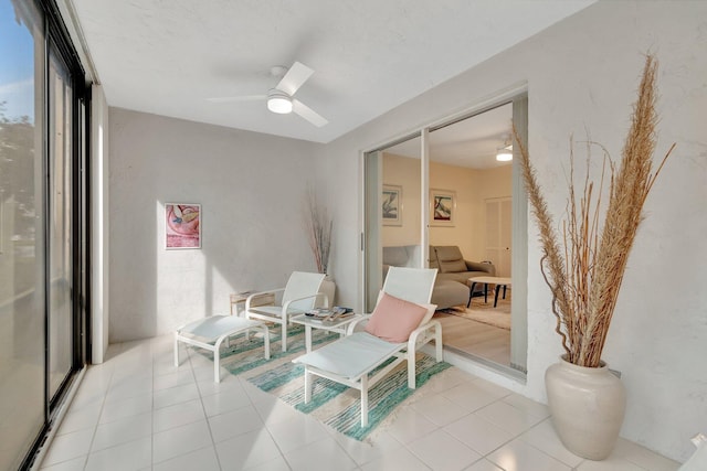 sunroom / solarium featuring ceiling fan