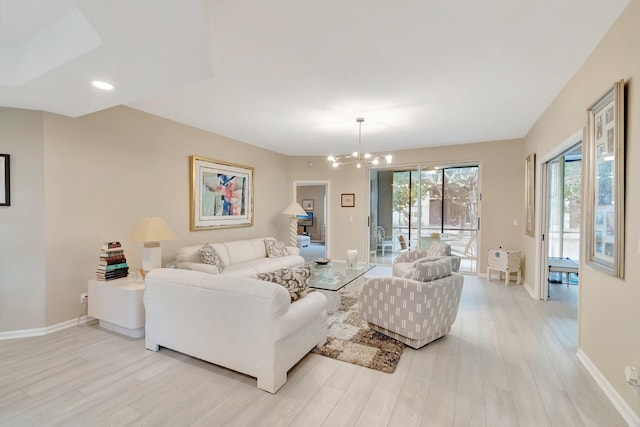 living room featuring light wood-type flooring and an inviting chandelier