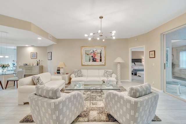 living room featuring a chandelier and light wood-type flooring