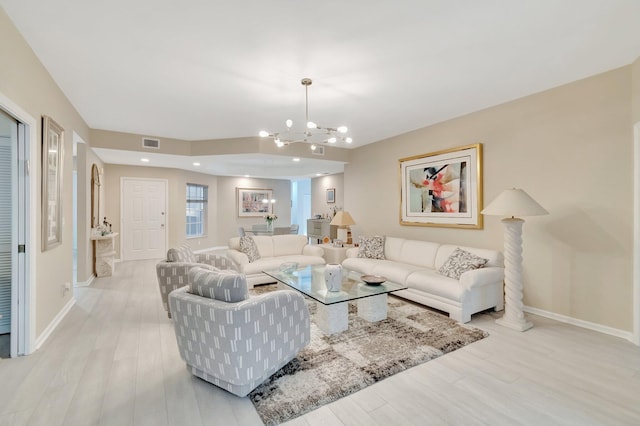 living room with a chandelier and light wood-type flooring