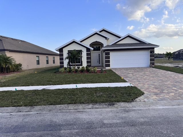 view of front of property featuring a garage and a front lawn