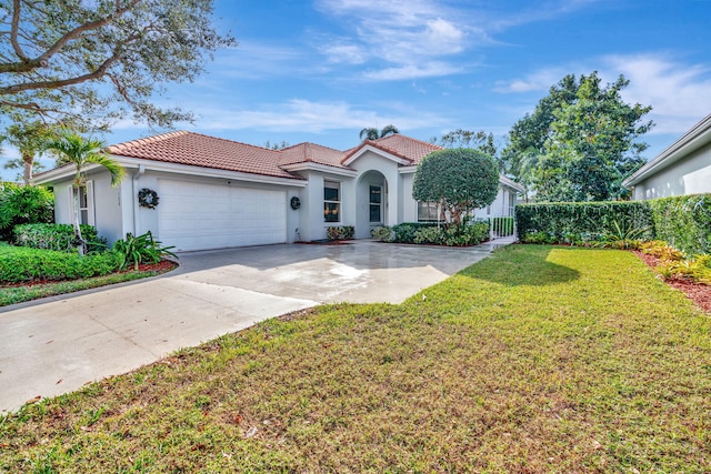 mediterranean / spanish-style home with a garage and a front yard