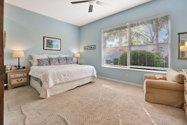 bedroom with ceiling fan and light carpet