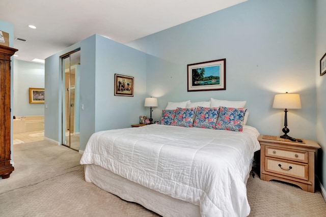 carpeted bedroom featuring ensuite bathroom