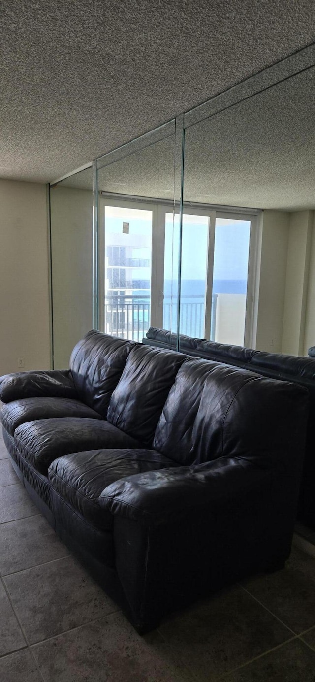 1149 Hillsboro Mile Unit 908, Hillsboro Beach, FL 33062 - living room featuring a textured ceiling