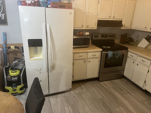 kitchen featuring stainless steel appliances and light hardwood / wood-style floors