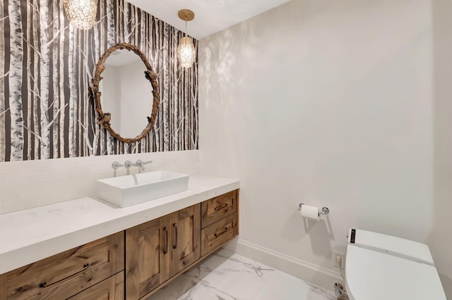 bathroom featuring vanity and toilet