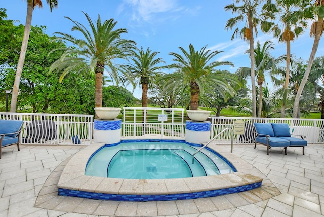 view of pool with an outdoor hangout area, a patio, and a hot tub