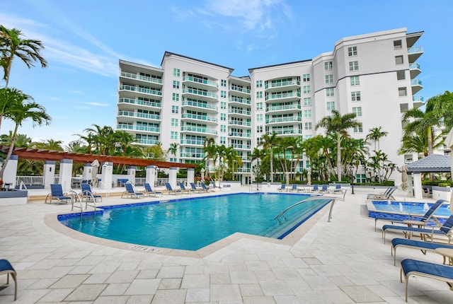 view of swimming pool with a patio area and a pergola