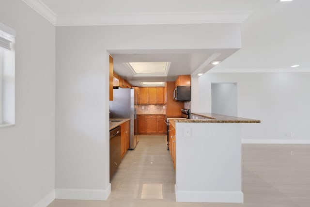 kitchen with stone counters, appliances with stainless steel finishes, backsplash, and ornamental molding