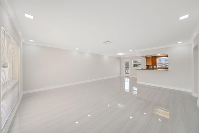 unfurnished living room with ornamental molding