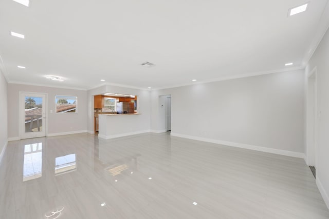 unfurnished living room featuring ornamental molding