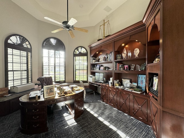 office space with ceiling fan and dark carpet