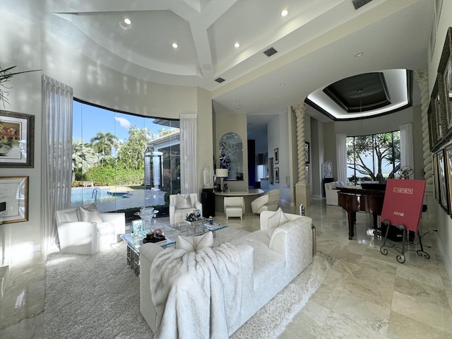 living room featuring a raised ceiling and a towering ceiling