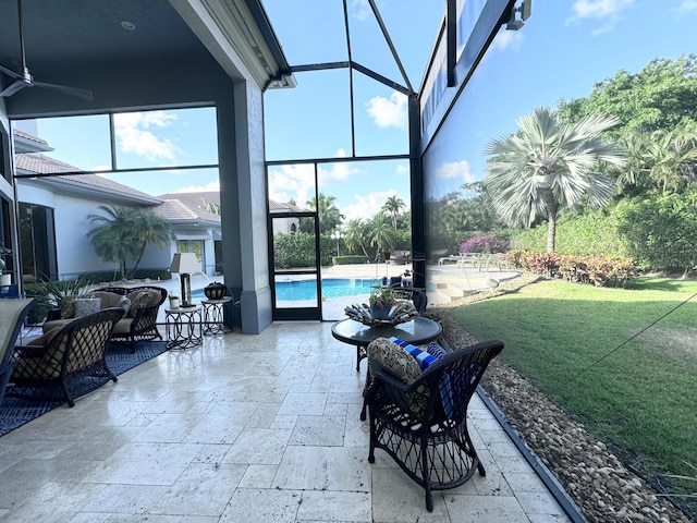 view of patio featuring glass enclosure and ceiling fan