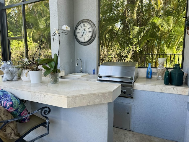 view of patio / terrace featuring an outdoor kitchen, area for grilling, and sink