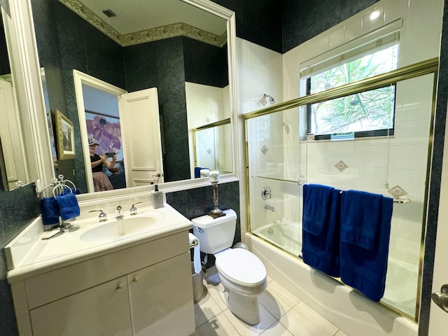 full bathroom featuring tile patterned flooring, vanity, enclosed tub / shower combo, and toilet