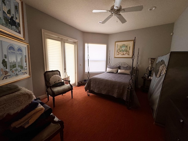 bedroom with carpet flooring, ceiling fan, and a textured ceiling