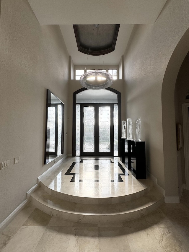 entrance foyer featuring an inviting chandelier