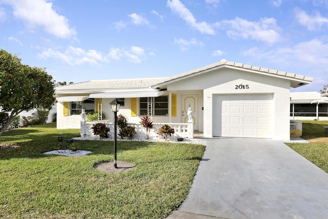 ranch-style home featuring covered porch, a garage, and a front lawn