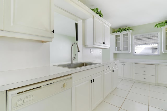 kitchen featuring white cabinetry, dishwasher, light tile patterned floors, and sink