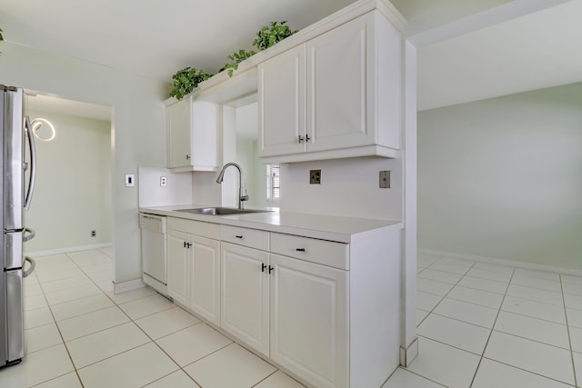 kitchen featuring stainless steel fridge, white cabinetry, sink, and dishwasher