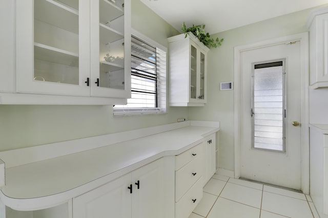 kitchen featuring white cabinets and light tile patterned flooring