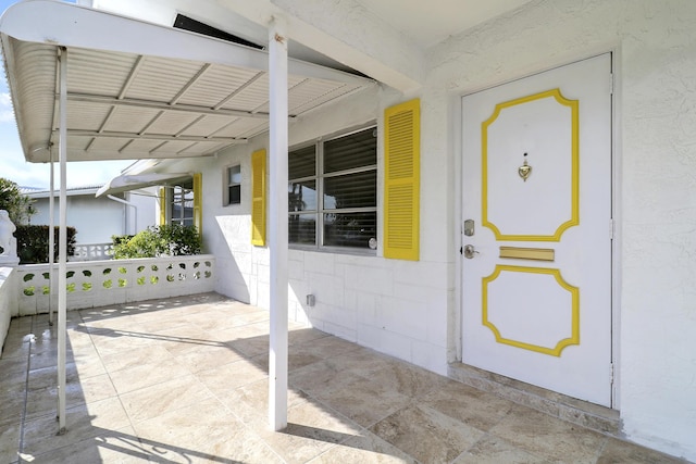 view of exterior entry featuring a carport